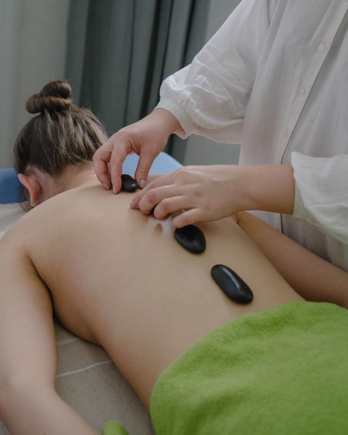 Mastering the First Impression: Your intriguing post title goes here A serene hot stone massage session indoors promoting relaxation and wellness.